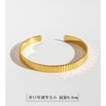 Wholesale gold cuff bracelet with vertical striped texture, 18K gold plated open bangle from JuneJewelry.com – minimalist luxury wrist jewelry.