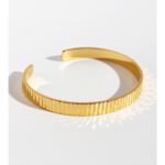 Wholesale gold cuff bracelet with vertical striped texture, 18K gold plated open bangle from JuneJewelry.com – minimalist luxury wrist jewelry.