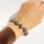 Wholesale spiral cuff bracelet with twisted wave coil design in 18K gold plated brass – Y2K fashion accessory from JuneJewelry.com.