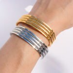 Wholesale shiny chain bracelet with open cuff design in 18K gold and platinum plated brass from JuneJewelry.com – fashion jewelry for bulk buyers.
