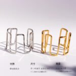 Wholesale geometric open bracelet in bold spiral hollow design, 18K gold or platinum plated brass cuff from JuneJewelry.com – cross-border statement jewelry.