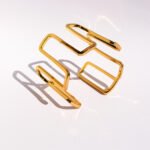 Wholesale geometric open bracelet in bold spiral hollow design, 18K gold or platinum plated brass cuff from JuneJewelry.com – cross-border statement jewelry.
