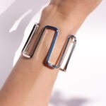 Wholesale geometric open bracelet in bold spiral hollow design, 18K gold or platinum plated brass cuff from JuneJewelry.com – cross-border statement jewelry.