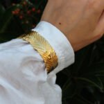 Wholesale statement feather bracelet with thick 3D abstract leaf design, 18K gold and platinum plated brass from JuneJewelry.com.