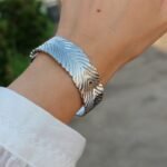 Wholesale statement feather bracelet with thick 3D abstract leaf design, 18K gold and platinum plated brass from JuneJewelry.com.