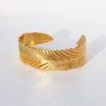Wholesale statement feather bracelet with thick 3D abstract leaf design, 18K gold and platinum plated brass from JuneJewelry.com.