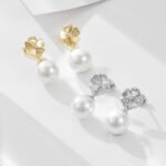 Wholesale Flower Pearl Drop Earrings, S925 sterling silver, with pearls and diamond-encrusted five-leaf clover flower design, available in 18K gold or platinum plating, European cross-border minimalist design, from junejewelry.com.