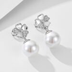 Wholesale Flower Pearl Drop Earrings, S925 sterling silver, with pearls and diamond-encrusted five-leaf clover flower design, available in 18K gold or platinum plating, European cross-border minimalist design, from junejewelry.com.