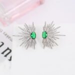 Wholesale starburst stud earrings with a central oval cubic zirconia and micro-pavé stones, platinum-plated brass and 925 silver needle from JuneJewelry.com.