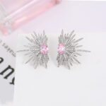 Wholesale starburst stud earrings with a central oval cubic zirconia and micro-pavé stones, platinum-plated brass and 925 silver needle from JuneJewelry.com.
