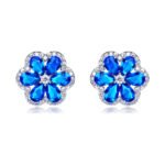Wholesale Colorful Flower Stud Earrings with a gold plated finish and emerald-colored and clear cubic zirconia stones from JuneJewelry.com – unique fashion jewelry for bulk orders.