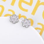 Wholesale Colorful Flower Stud Earrings with a gold plated finish and emerald-colored and clear cubic zirconia stones from JuneJewelry.com – unique fashion jewelry for bulk orders.