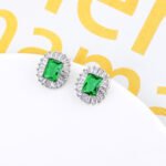 Wholesale emerald cut stud earrings with a starburst halo of CZ stones, a platinum-plated brass base, and 925 silver needle from junejewelry.com.