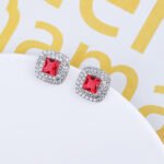 Wholesale square halo stud earrings with a double halo of CZ stones, a platinum-plated brass base, and 925 silver needle from junejewelry.com.