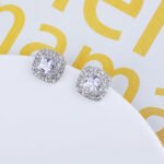 Wholesale square halo stud earrings with a double halo of CZ stones, a platinum-plated brass base, and 925 silver needle from junejewelry.com.