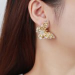 Wholesale Butterfly Stud Earrings with gold plating and cubic zirconia stones from JuneJewelry.com – unique fashion jewelry for bulk orders.