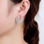 Wholesale CZ drop earrings with fan-shaped crystal and zircon stones, featuring a 925 silver needle and gold plating from JuneJewelry.com, ideal for bridal and fashion jewelry wholesale.
