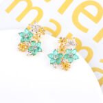 Wholesale Colorful Flower Stud Earrings with a gold plated finish and ruby-colored and clear cubic zirconia stones from JuneJewelry.com – unique fashion jewelry for bulk orders.
