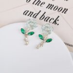 Wholesale Flower Dangle Earrings with a gold plated finish and green and clear cubic zirconia stones from JuneJewelry.com – unique fashion jewelry for bulk orders.