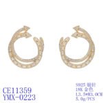 Wholesale gold twisted hoop earrings with baguette and pavé CZ stones from junejewelry.com – unique fashion jewelry for bulk orders.
