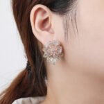 Wholesale gold flower stud earrings with pink and white CZ pavé stones and a 925 silver needle from junejewelry.com – unique fashion jewelry for bulk orders.
