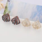 Wholesale gold fan stud earrings with baguette and pavé CZ stones from junejewelry.com – unique fashion jewelry for bulk orders.