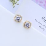 Wholesale Gold Plated Stud Earrings with a cushion-cut cubic zirconia stone on an ornate gold plated brass base from JuneJewelry.com – elegant fashion jewelry for bulk orders.