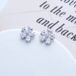 Wholesale Pear Halo Stud Earrings with a silver plated finish and clear cubic zirconia stones from JuneJewelry.com – unique fashion jewelry for bulk orders.