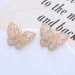 Wholesale butterfly stud earrings with baguette and pavé CZ stones on a platinum-plated brass base and 925 silver needle from junejewelry.com – unique fashion jewelry for bulk orders.
