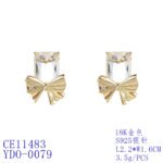 Wholesale starburst stud earrings with a central oval CZ and pavé stones on a platinum-plated brass base from junejewelry.com – unique fashion jewelry for bulk orders.