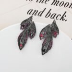 Wholesale Butterfly Stud Earrings with a silver plated finish and clear cubic zirconia stones from JuneJewelry.com – unique fashion jewelry for bulk orders.