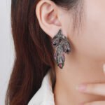 Wholesale Butterfly Stud Earrings with a silver plated finish and clear cubic zirconia stones from JuneJewelry.com – unique fashion jewelry for bulk orders.