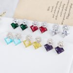 Wholesale geometric drop earrings with a square-cut CZ stone and baguette circle top from junejewelry.com – modern fashion jewelry for bulk orders.