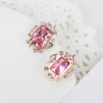 Wholesale zircon stud earrings with a clear rectangular stone and cluster on rhodium plated copper and 925 sterling silver pins from JuneJewelry.com – elegant fashion jewelry for bulk orders.