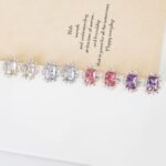 Wholesale zircon stud earrings with a clear rectangular stone and cluster on rhodium plated copper and 925 sterling silver pins from JuneJewelry.com – elegant fashion jewelry for bulk orders.