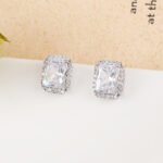 Wholesale square halo stud earrings with a double halo of CZ stones, a platinum-plated brass base, and 925 silver needle from junejewelry.com.