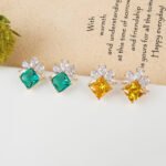 Wholesale gemstone stud earrings with a zircon flower cluster on gold plated copper and 925 sterling silver pins from JuneJewelry.com – elegant fashion jewelry for bulk orders.