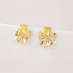 Wholesale bow zircon earrings with a clear rectangular stone, platinum-plated copper, and 925 silver needles from JuneJewelry.com.
