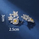 Wholesale pink flower earrings with a zircon flower cluster on rhodium plated copper and 925 sterling silver pins from JuneJewelry.com – elegant floral jewelry for bulk orders.