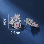 Wholesale pink flower earrings with a zircon flower cluster on rhodium plated copper and 925 sterling silver pins from JuneJewelry.com – elegant floral jewelry for bulk orders.