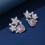 Wholesale pink flower earrings with a zircon flower cluster on rhodium plated copper and 925 sterling silver pins from JuneJewelry.com – elegant floral jewelry for bulk orders.