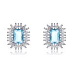 Wholesale blue gemstone earrings with a zircon sunburst on rhodium plated copper and 925 sterling silver pins from JuneJewelry.com – elegant fashion jewelry for bulk orders.