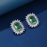 Wholesale blue gemstone earrings with a zircon sunburst on rhodium plated copper and 925 sterling silver pins from JuneJewelry.com – elegant fashion jewelry for bulk orders.