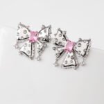 Wholesale pink bow stud earrings with white and pink cubic zirconia on a platinum plated copper base with a 925 silver needle from JuneJewelry.com.