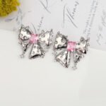 Wholesale pink bow stud earrings with white and pink cubic zirconia on a platinum plated copper base with a 925 silver needle from JuneJewelry.com.