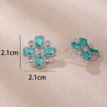 Wholesale blue zircon cross earrings with rectangular and round cubic zirconia stones, platinum plated on a copper base with a 925 silver needle, from JuneJewelry.com.