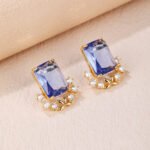 Wholesale blue zircon flower earrings with a rectangular blue stone and a floral design with white cubic zirconia, platinum plated with a 925 silver needle, from JuneJewelry.com.