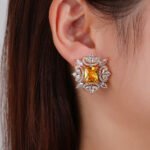 Wholesale pink gemstone earrings with a gold plated setting and zircon halo on 925 sterling silver pins from JuneJewelry.com – unique fashion jewelry for bulk orders.