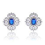 Wholesale ruby red gemstone earrings with a clear zircon cluster on rhodium plated copper and 925 sterling silver pins from JuneJewelry.com – elegant fashion jewelry for bulk orders.