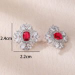 Wholesale ruby red gemstone earrings with a clear zircon cluster on rhodium plated copper and 925 sterling silver pins from JuneJewelry.com – elegant fashion jewelry for bulk orders.